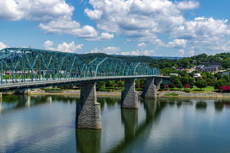 there is a blue bridge that crosses over the water