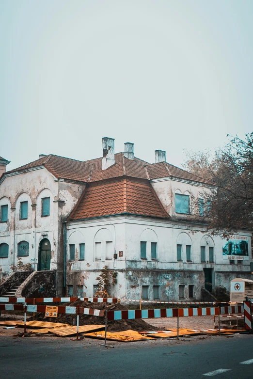 a large white building sitting on the side of a road