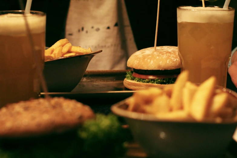 different types of food including burgers, fries, drinks and ketchup are shown here