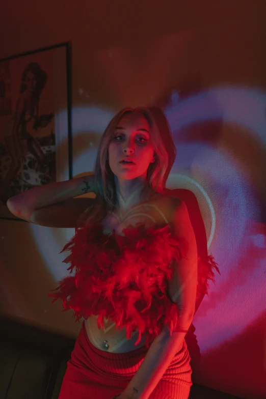 a woman wearing red feathers on her skirt