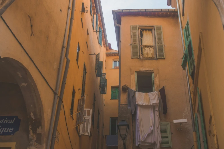 a narrow street has a laundry line on the side