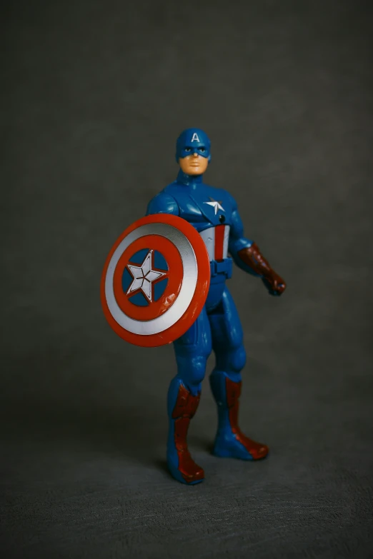 a toy captain figure holding a shield is displayed