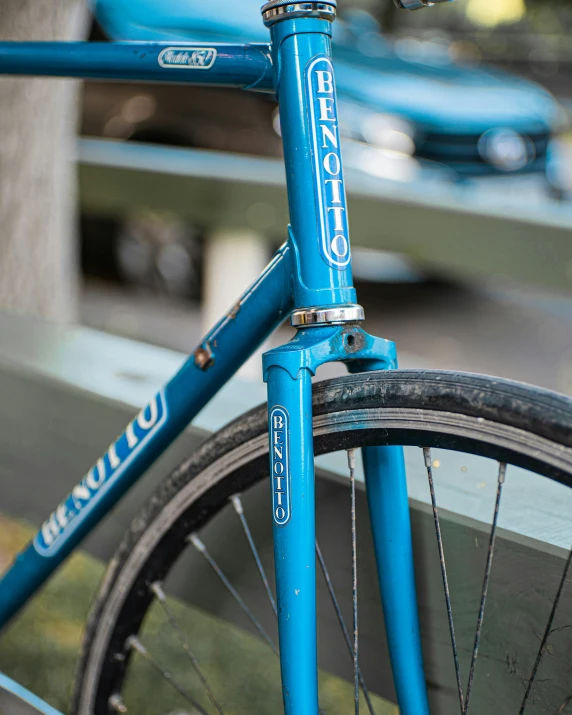 the bicycle is locked to the side of the bench