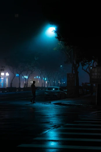 a person is crossing the street at night