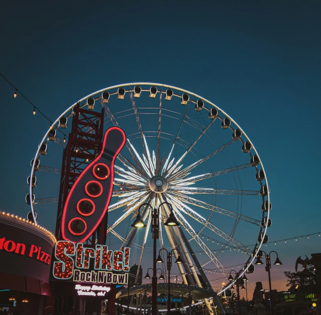 an amut park that has a ferris wheel at the end of the ride