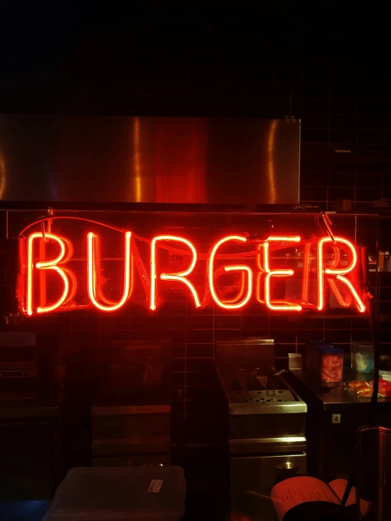 a hamburger sign with some lit up lights hanging