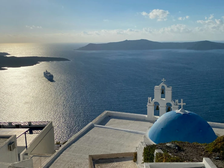 an aerial view of an ocean with cruise ship in the background