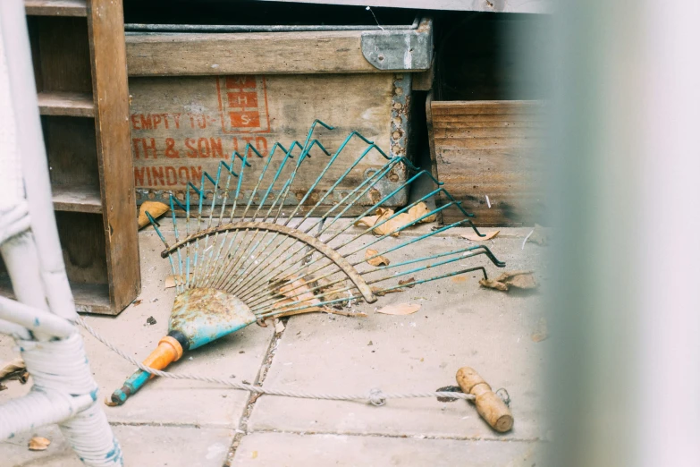 a broken decorative fan lies on the floor