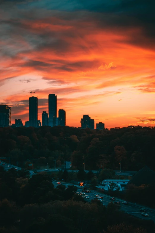 a city skyline at dusk with red sky