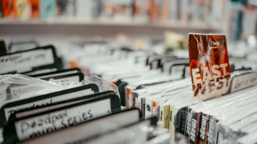 some books sitting on the edge of a book case