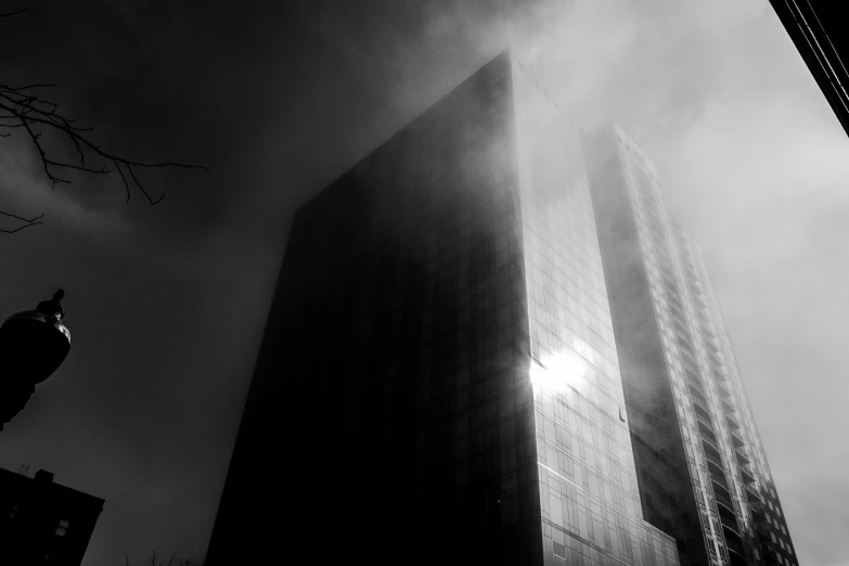 a black and white po of fog surrounding the corner of a building