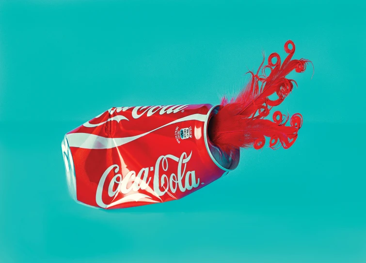 a red coca cola bottle is being lowered from the air