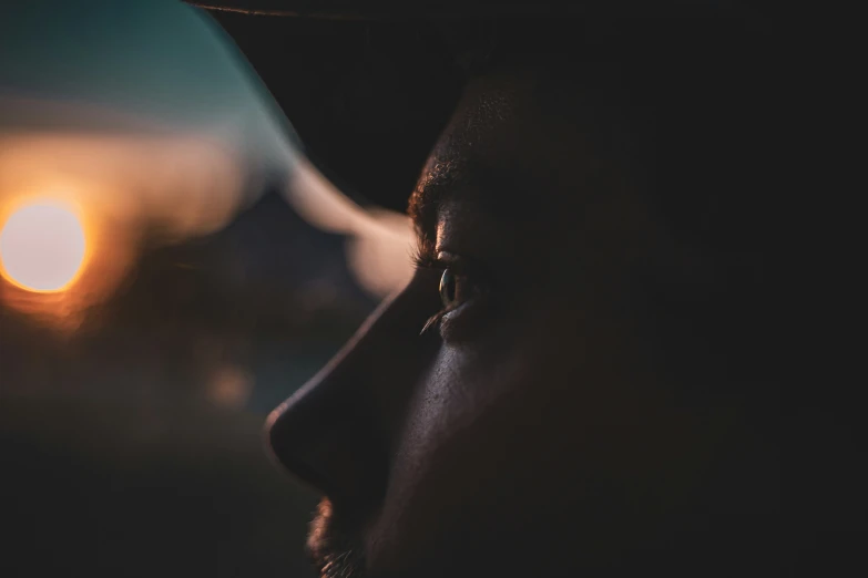 a man with eye shadow and dark hat