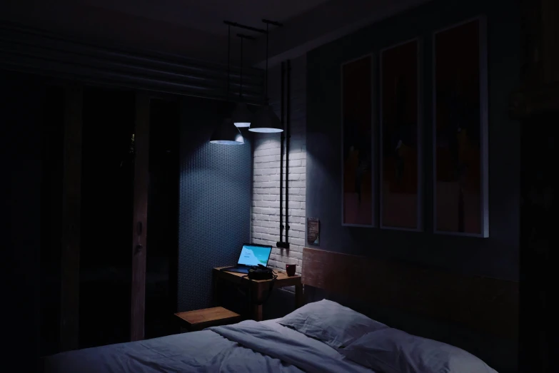 a laptop on a bed at night in the dark