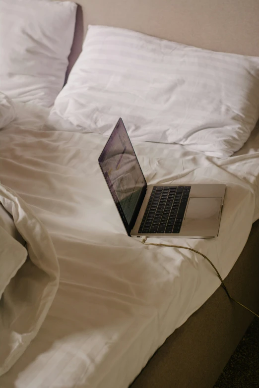 there is a lap top on a bed