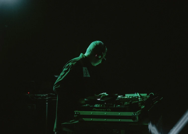 a dj mixes up for music with his dj equipment