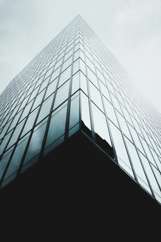 a high rise building in front of a grey sky