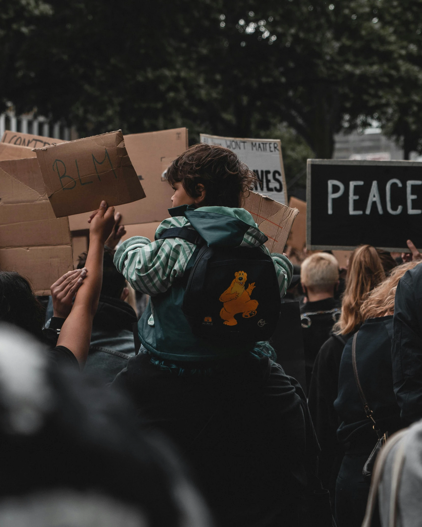 a person with a large backpack on his back holds a sign