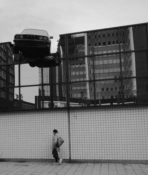 man standing in front of a white wall in the city