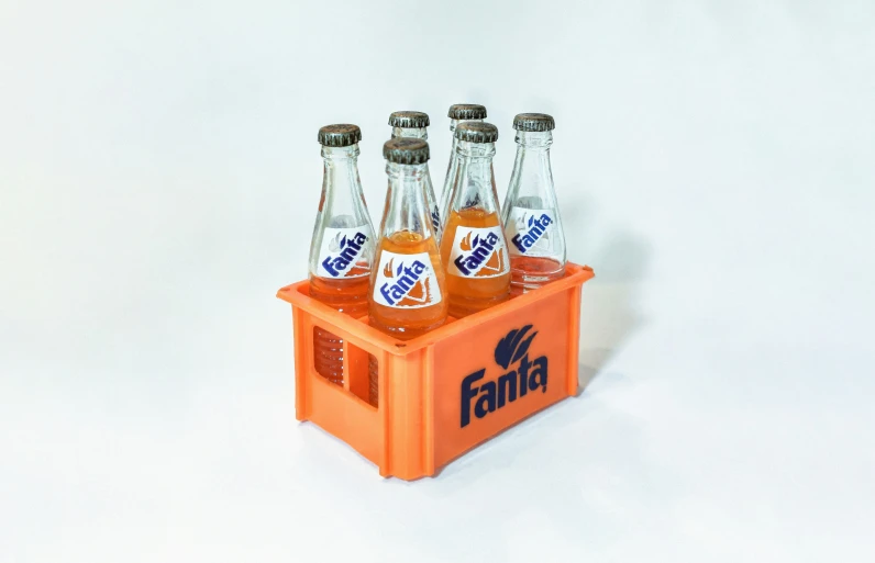 there are five fifita beer bottles in a orange crate