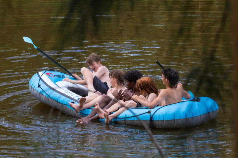 a group of s are rafting in the lake