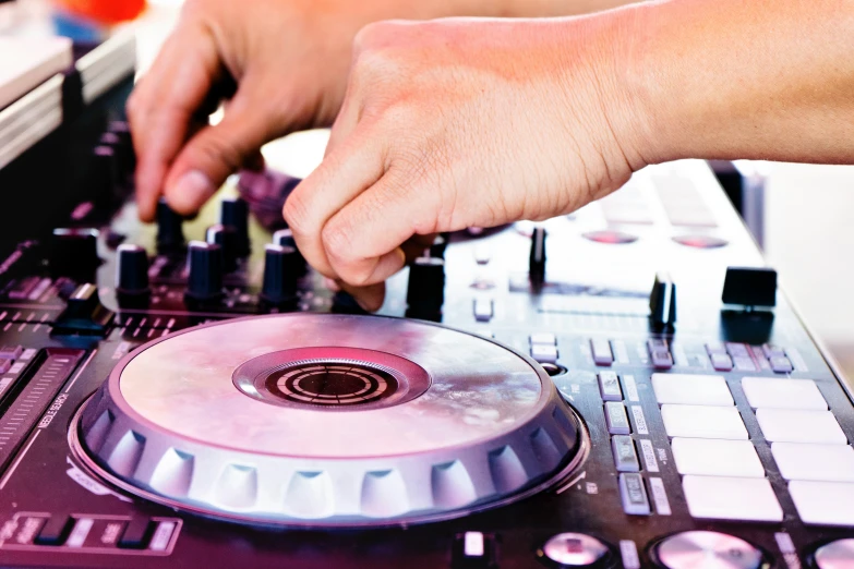 the dj uses the control for his electronic work