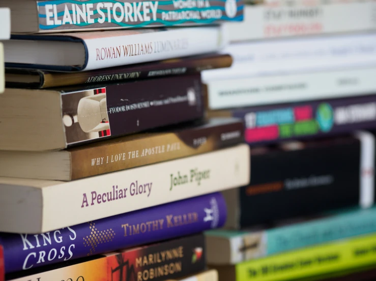 a bunch of books are stacked up together