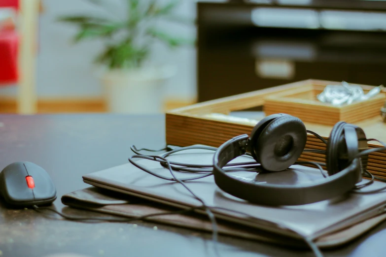 a desk with headphones and papers on it