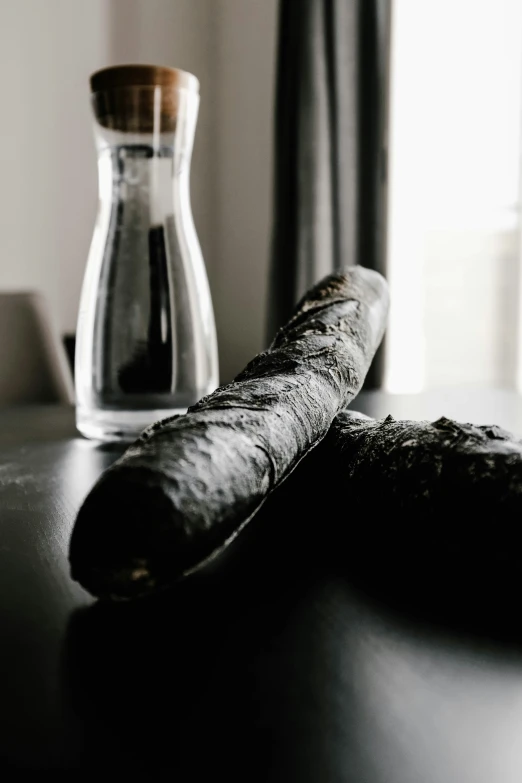 a close up of a pastry on a table with a bottle of coffee