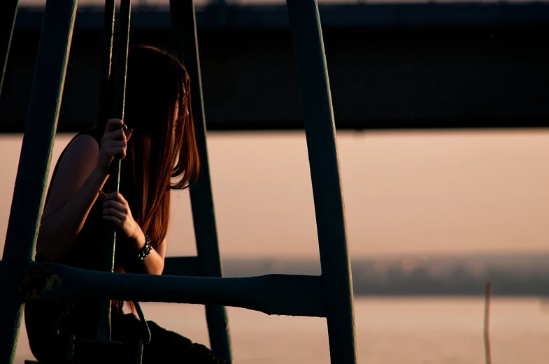 a person sitting down with their cell phone to the side