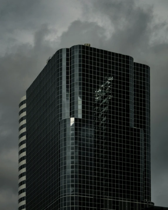 a building with a large window on top in a cloudy sky