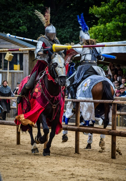 two men dressed up in medieval armor on horses