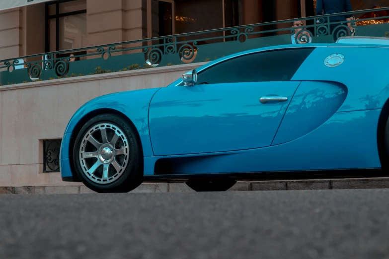 blue bugatti parked on the side of the road