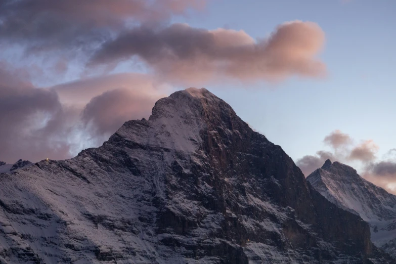 the view of mountain peaks from below the clouds