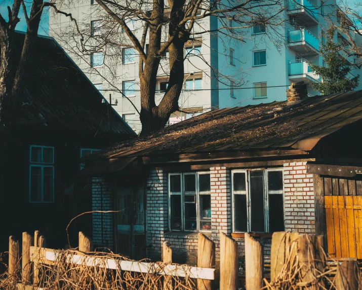 a building behind a wooden fence in front of buildings