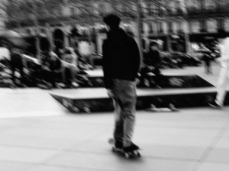 skateboarder in motion moving up sidewalk in a park