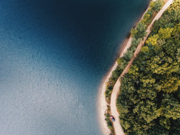 a beautiful blue lake in the middle of a forest