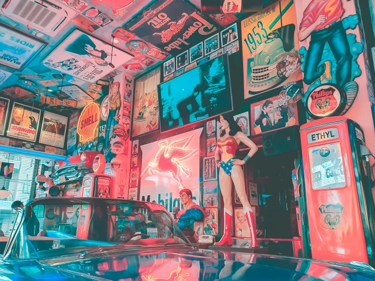 woman stands near an automobile in front of an array of advertits