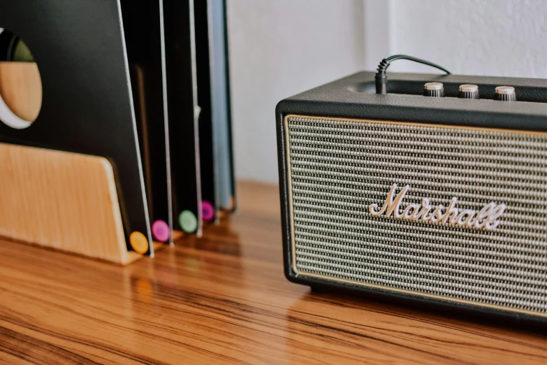 an old fashion speaker next to some folders