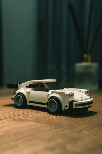 a lego model sports car sits on the floor