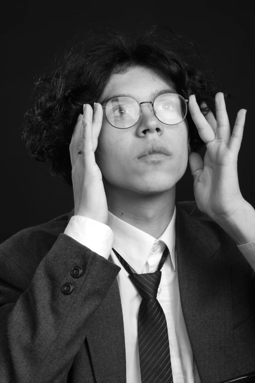 an asian man wearing a tie and glasses