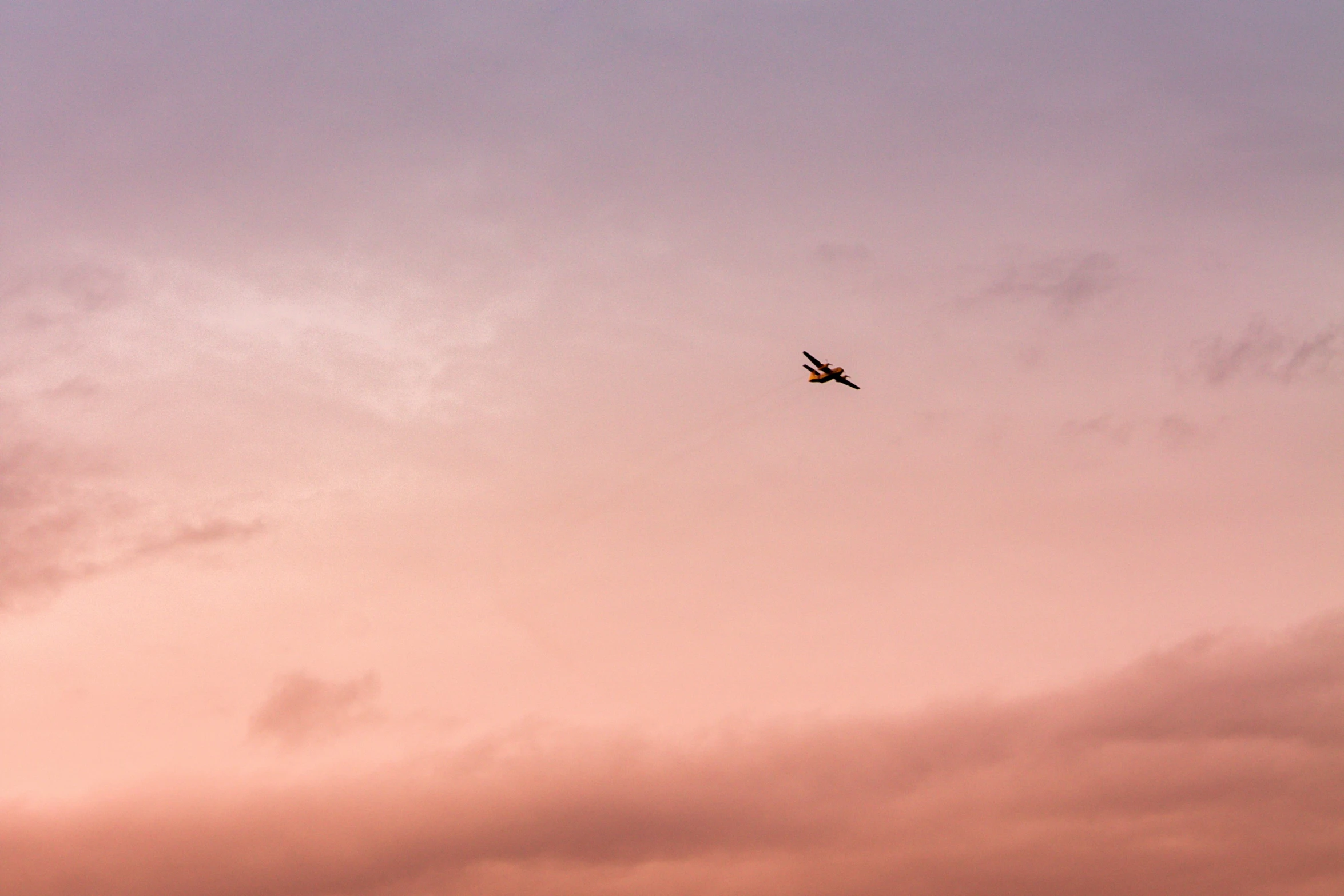 a plane flying high above the clouds in the sky