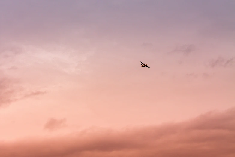 a plane flying high above the clouds in the sky