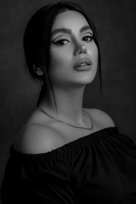 a woman in black dress wearing a necklace and choker