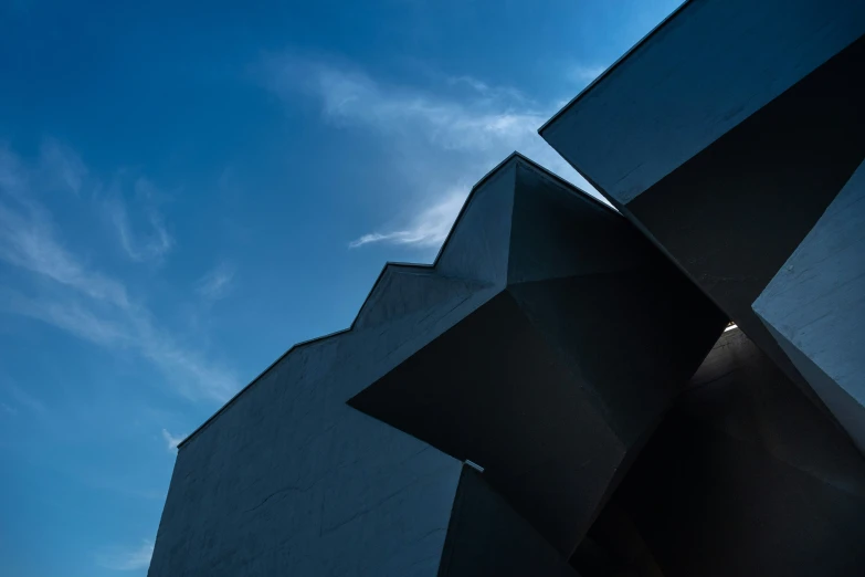 low angle view looking up at the underside of an arty black building