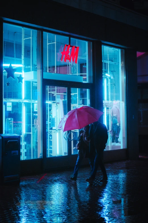 a man walking past a store with a red umbrella