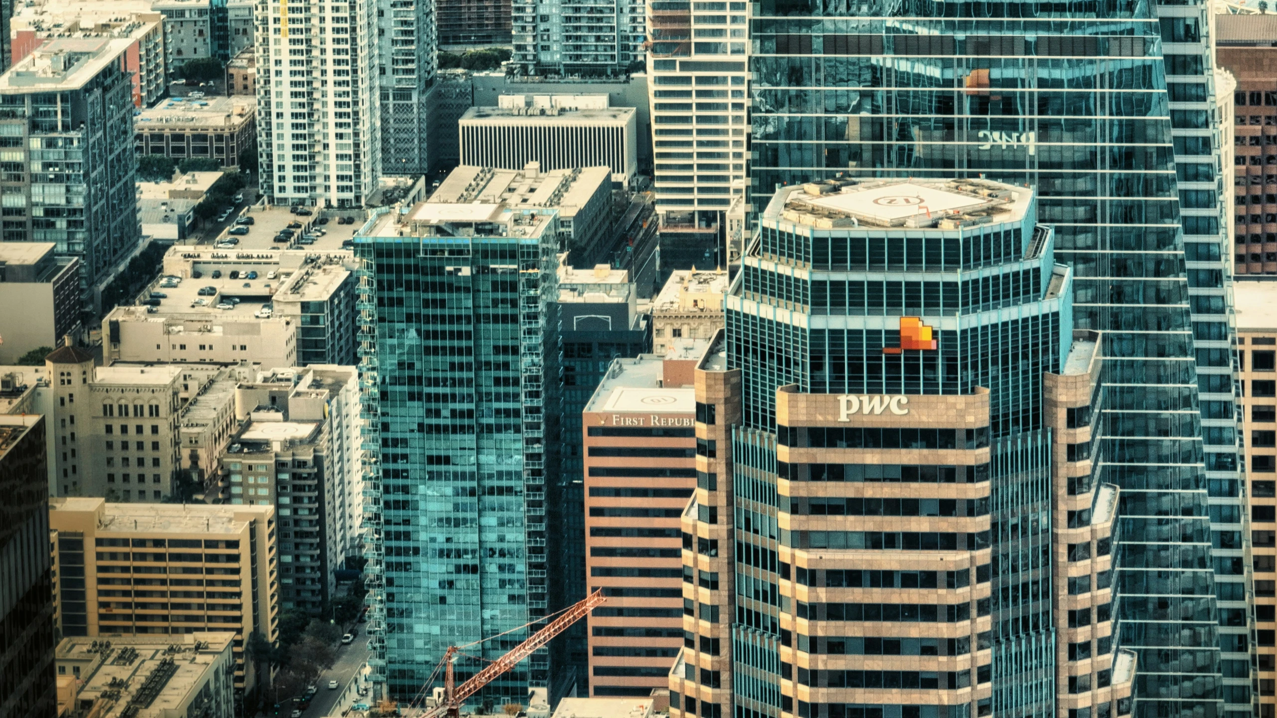 a big city with tall buildings that is surrounded by cranes