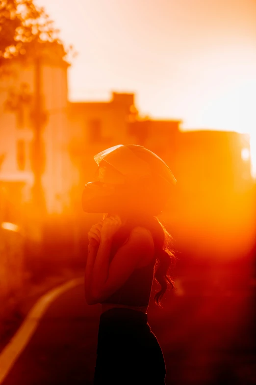 a woman walking down the road wearing a hat