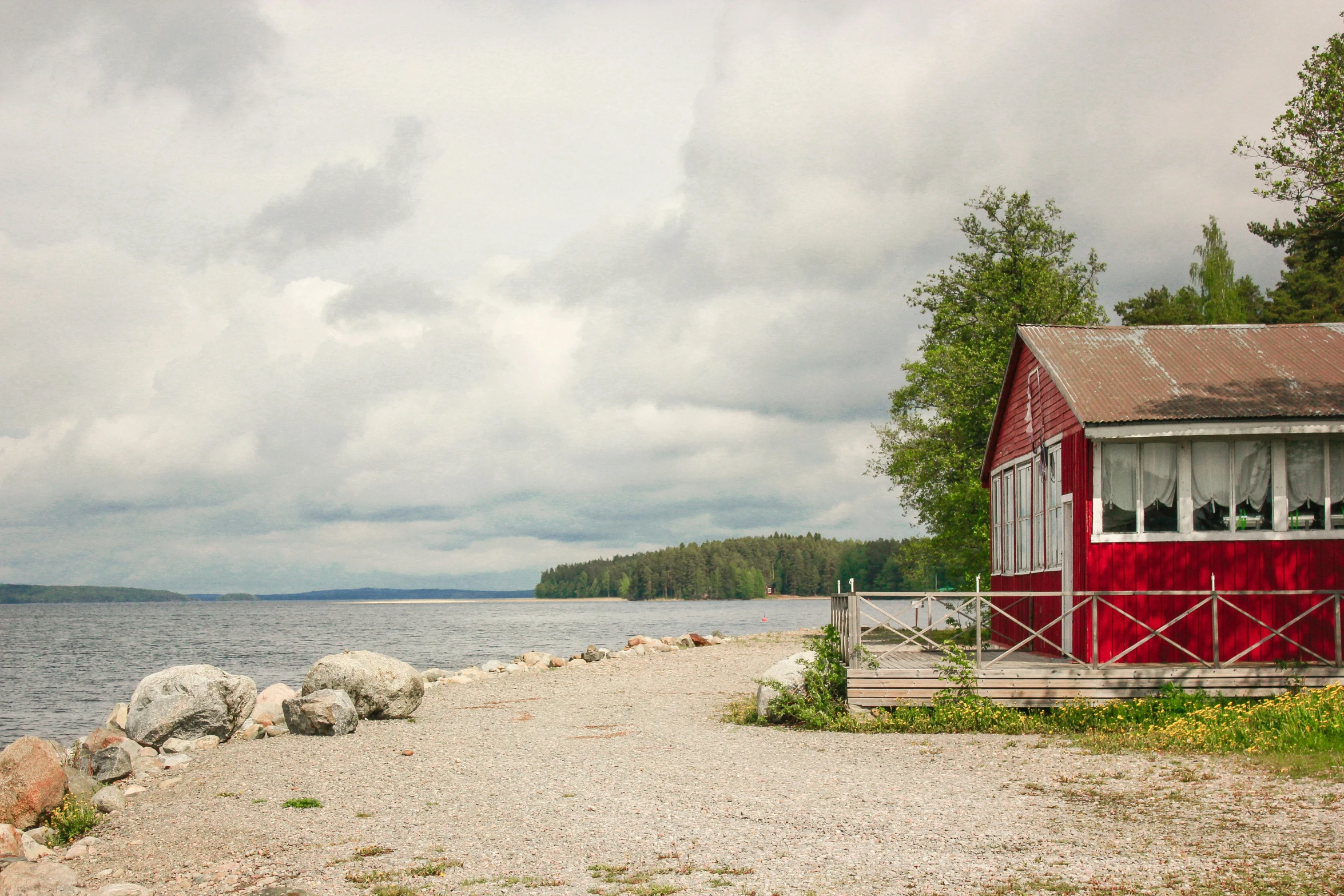 the water is choppy and cloudy and red shack