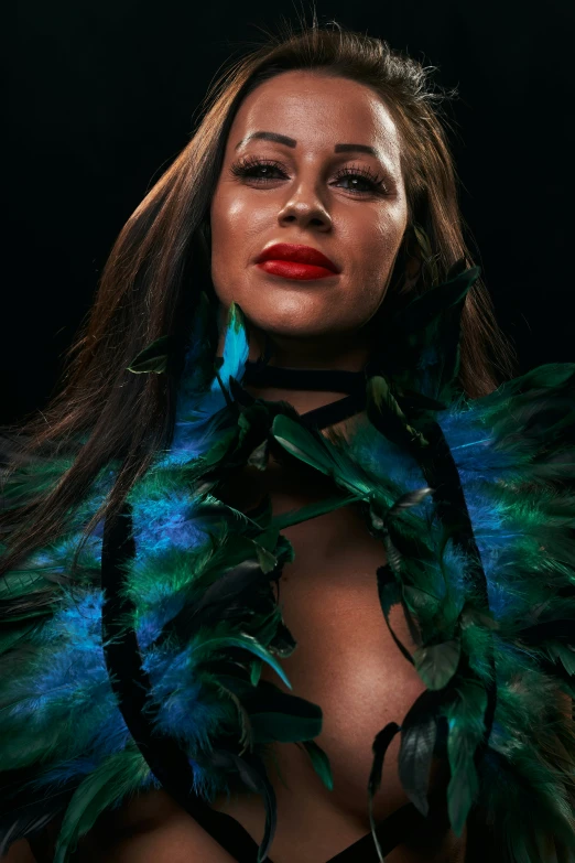 a woman with feathers around her neck in a po